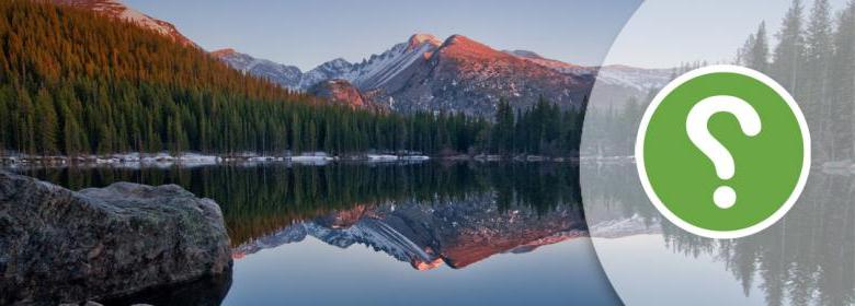 question mark icon over serene mountain lake scene banner